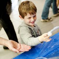Dexter resident Isak Starback, 4, plays with dry ice bubbles during the Mini Maker Faire on Saturday, June 8. Daniel Brenner I AnnArbor.com